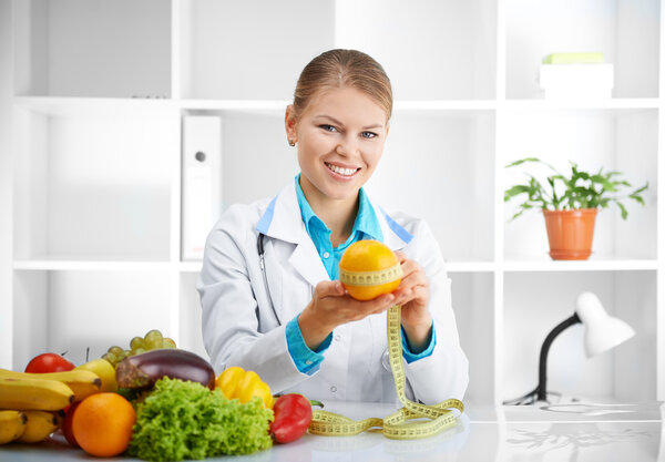 Dietitian holding apple with tape