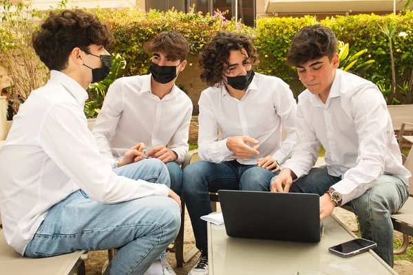 Groupe d'étudiants travaillant à une table WIth ordinateur portable Photo De Stock