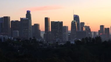 Gökyüzünün kararması ve Los Angeles şehir merkezindeki gökdelenlerin ışıklarının yanması.