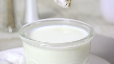 Pudra şekerli çöreği bir bardak süte batırmak.