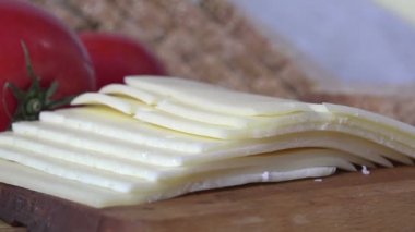 Bir dilim İsviçre peynirini alıp ekmeğin üstüne koyuyorum.