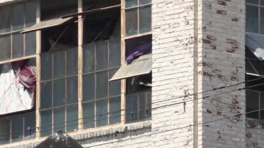 Çarşaflar ve çamaşırlar kurusun diye pencereden sarkıyor.