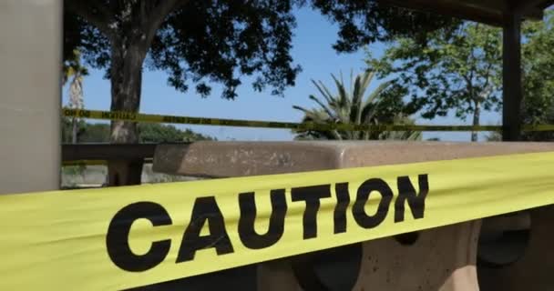Zamknij Taśmę Ostrzeżeniem Zamykającą Stoły Piknikowe Parku Podczas Epidemii Koronawirusa — Wideo stockowe
