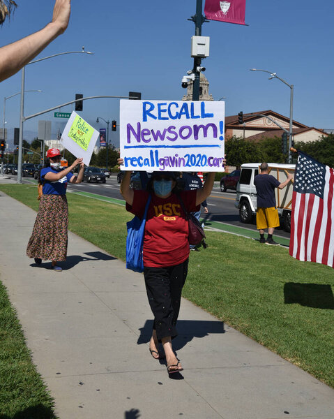 Beverly Hills, CA/USA - Aug 1, 2020: Woman with a Recall Gavin Newsom sign at a patriotic rally