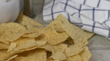 Mısır tortilla parçaları yavaş çekimde tezgaha düşüyor.