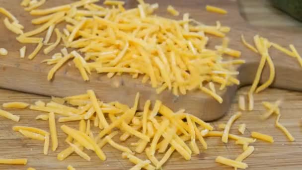 Grated Cheese Falling Wooden Cutting Board Slow Motion — 图库视频影像