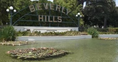Iconic Beverly Hills tabelası ve önündeki zambak havuzu.