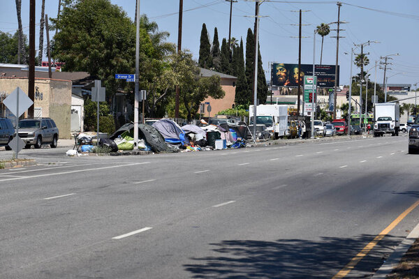 Los Angeles, CA USA - June 30, 2021: Homeless encampment on a traffic island on Venice Boulevard 