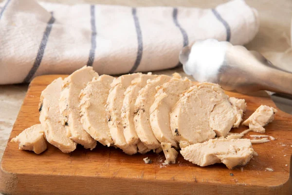 将烤好的鸡胸肉放在木制切菜板上 — 图库照片
