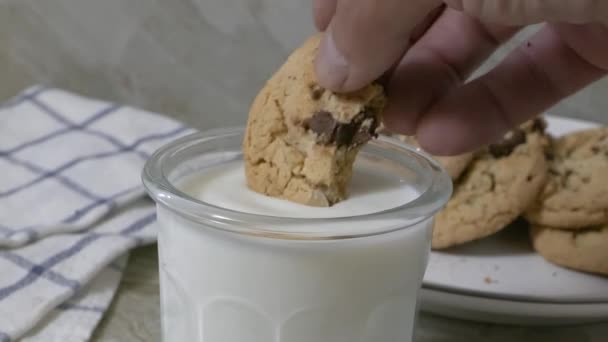 将一块巧克力饼干倒入一杯牛奶中 速度不一 — 图库视频影像