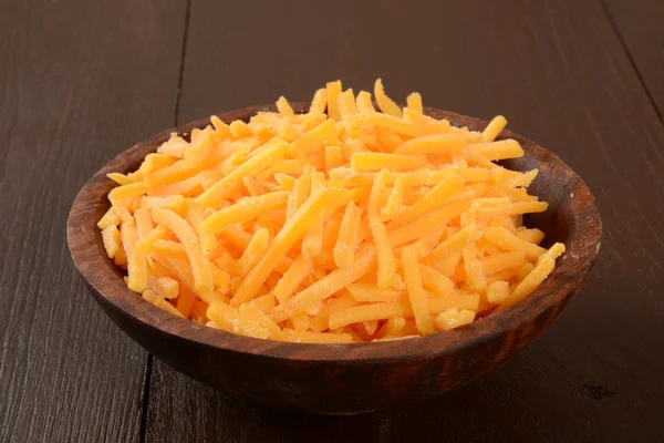 Bowl of grated cheddar cheese — Stock Photo, Image