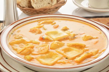 Lobster and ravioli in seafood bisque clipart