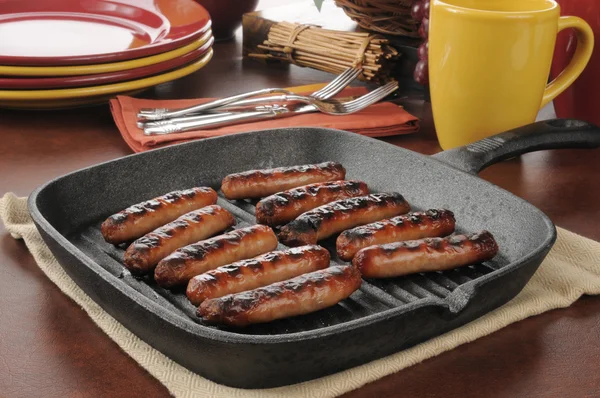 Link sausages on hot pad — Stock Photo, Image