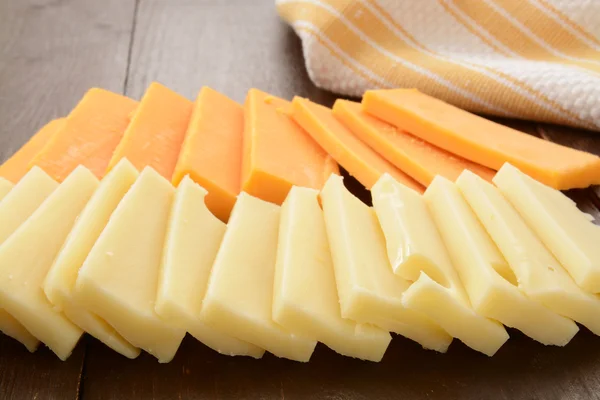 Sharp cheddar and swiss cheeses — Stock Photo, Image