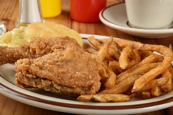 Plate with chicken and french fries — Stock Photo, Image