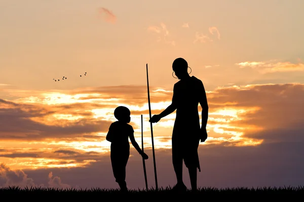 Afrikansk man och son vid solnedgången — Stockfoto