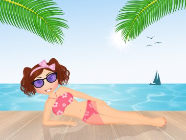 Kumsalda güneşlenen kız.