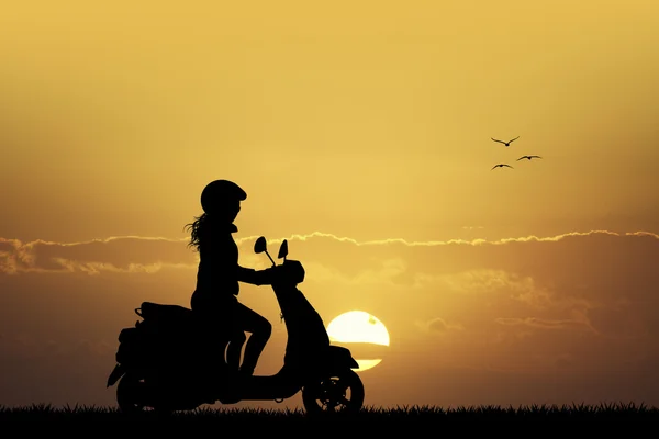 Girl on scooter at sunset — Stock Photo, Image