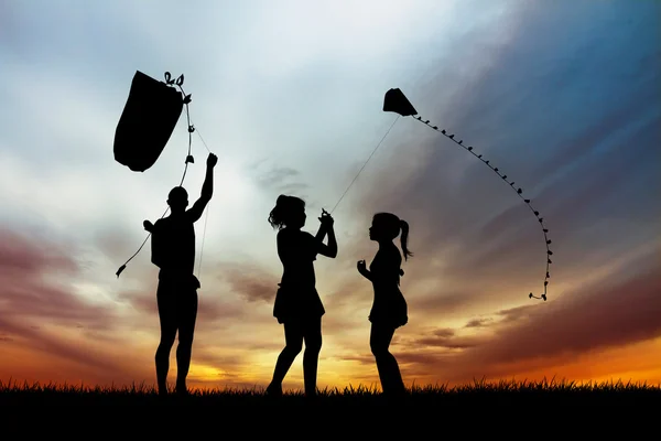 People with kite at sunset — Stock Photo, Image