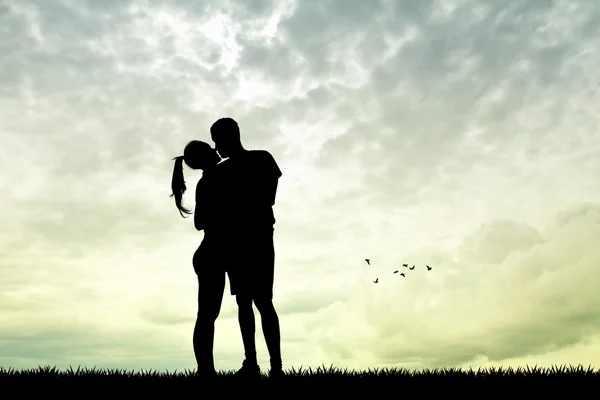 Man and girl kissing at sunset — Stock Photo, Image