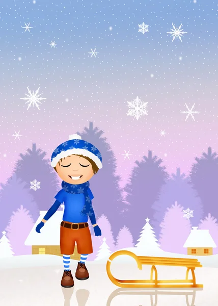 Ребенок с санями в снегу — стоковое фото