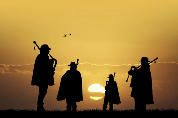 Pipers at sunset — Stock Photo, Image