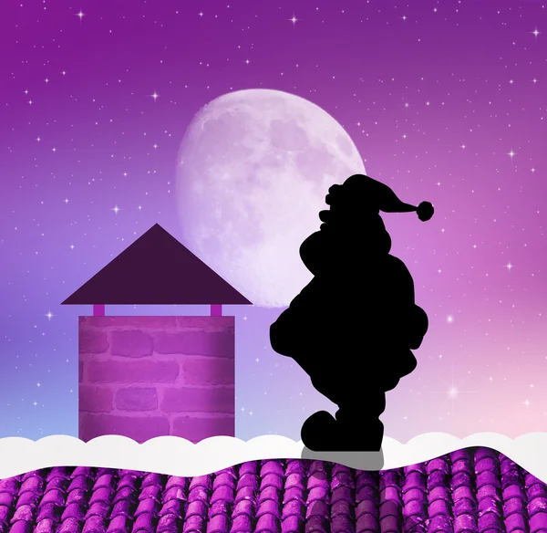 Santa claus na dachu — Zdjęcie stockowe