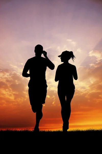 Couple running  at sunset — Stock Photo, Image