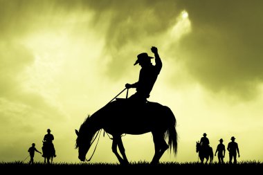rodeo cowboy slhouette at sunset