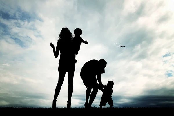 Family silhouette at sunset — Stock Photo, Image