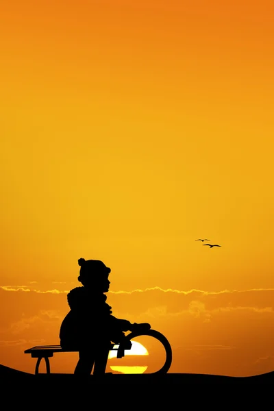 Child on sleigh in winter at sunset — Stock Photo, Image