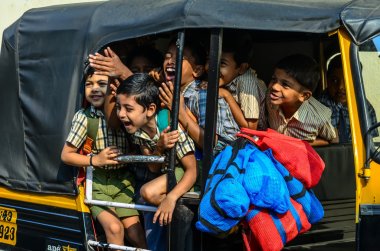 Indian school children going home by a rickshaw clipart