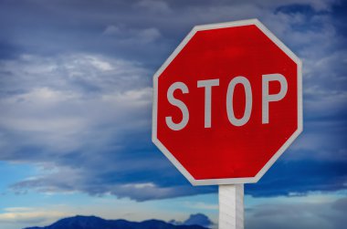 roadside red stop sign on a cloudy background. clipart