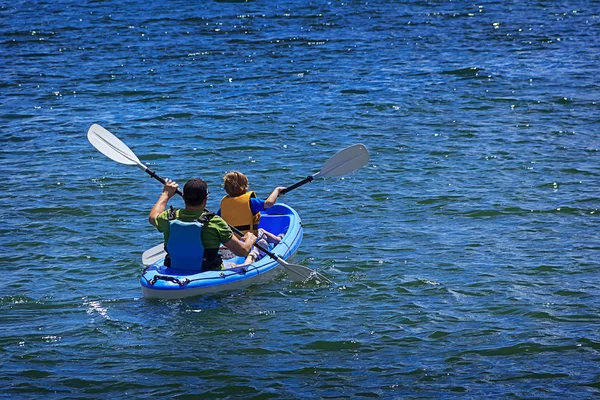 Happy little boy with his father kayaking at ocean — Stock Photo, Image