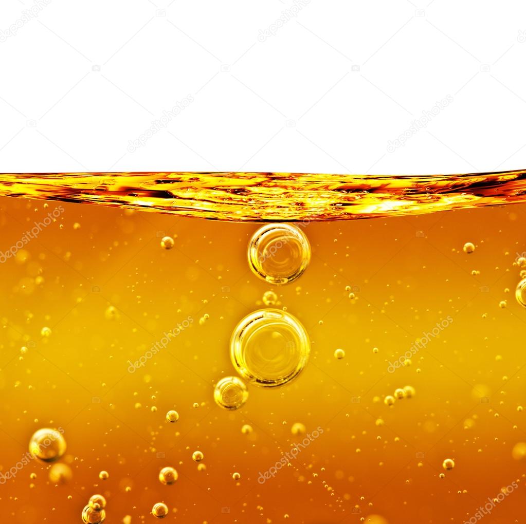 Oil background yellow liquid with air bubbles. Stock Photo by