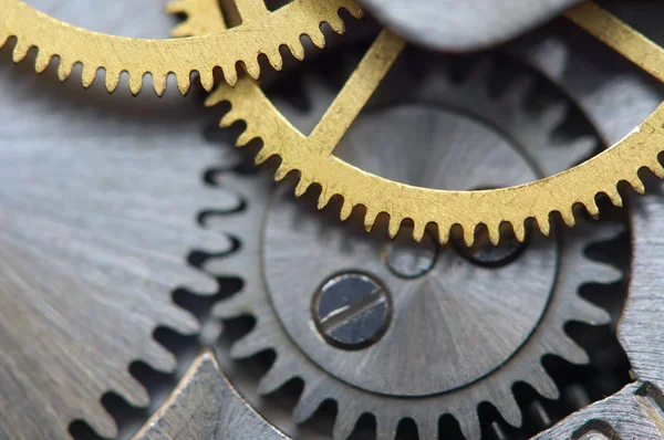 Fondo con ruedas dentadas de metal un reloj. Macro —  Fotos de Stock