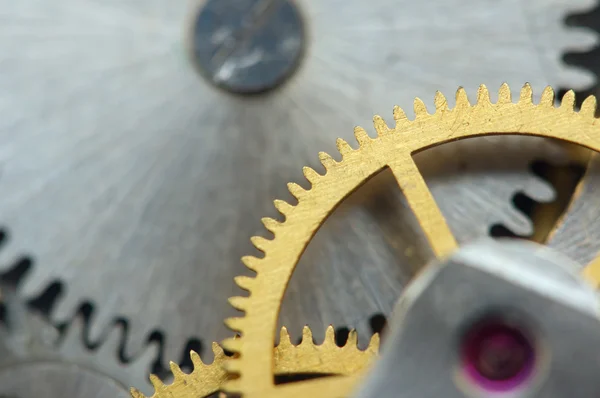 Στο παρασκήνιο με μεταλλικά γρανάζια για ένα ρολόι. μακροεντολή — Φωτογραφία Αρχείου