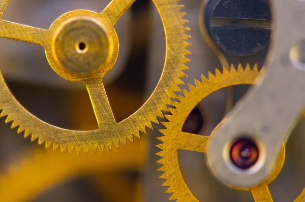 Fondo con ruedas dentadas de metal un reloj . — Foto de Stock