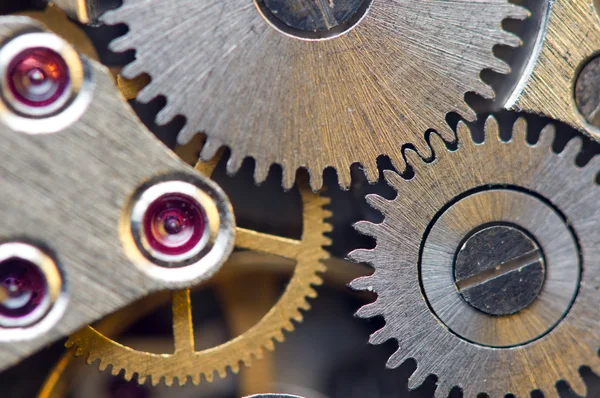 Fondo metálico con ruedas dentadas de metal un reloj. Macro — Foto de Stock