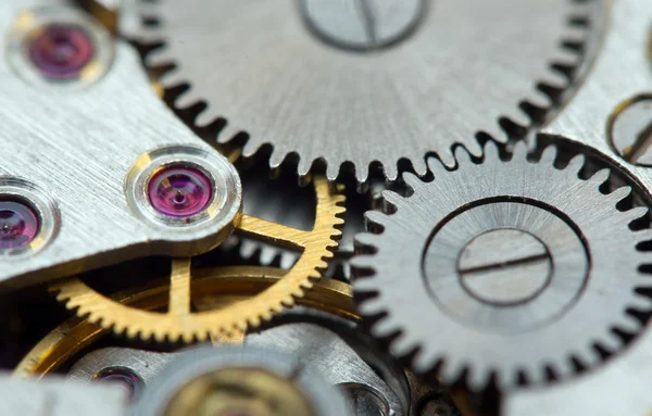 Μεταλλικό φόντο με μεταλλικά γρανάζια για ένα ρολόι. μακροεντολή — Φωτογραφία Αρχείου