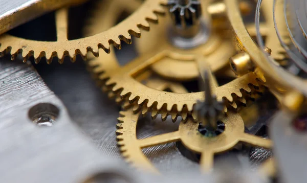 Fondo con ruedas dentadas de metal un reloj. Foto conceptual — Foto de Stock