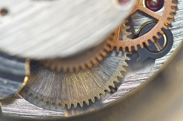 Sfondo con ruote dentate in metallo un orologio. Foto concettuale — Foto Stock