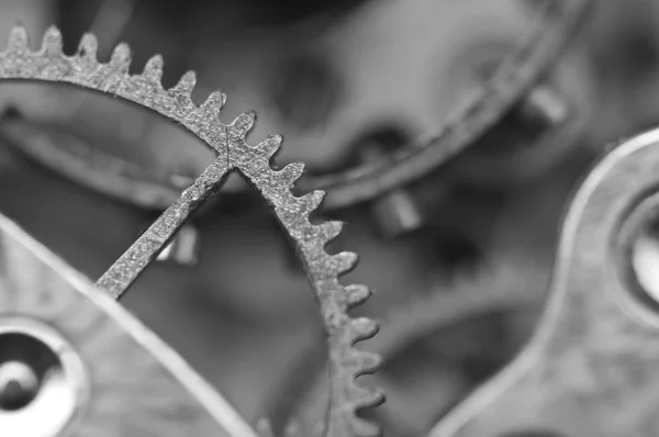 Zwart witte achtergrond met metalen tandwielen een oude uurwerk. — Stockfoto