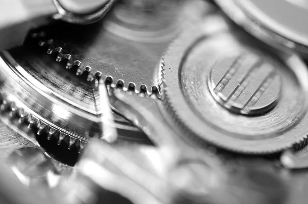 Arrière-plan avec roues dentées en métal une horloge. Macro — Photo