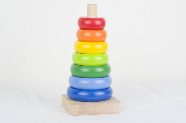 colorful wooden toy tower on white background 