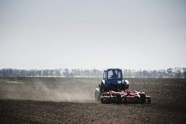 Traktor på ett fält — Stockfoto