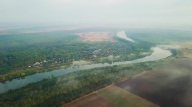 Yavaşça bir nehir kıyısına bakıyorum Dinyester ve sabah güneşiyle kaplı küçük bir köy..