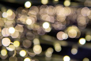 Yılbaşı çelenklerinin arka planı yıldızlar gibi. Noel atmosferinde çelenkler yankılanıyor.