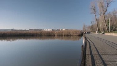 5 Aralık 2021. Kishinev, Moldova Cumhuriyeti. İnsanlar gün boyunca gölün yanındaki parkta yürürler.