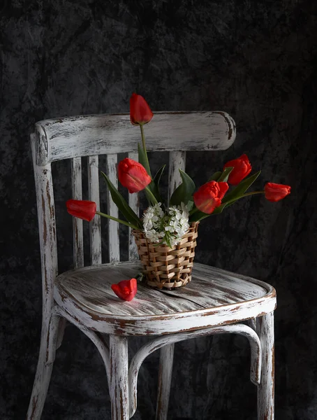 Red tulips bouquet in wooden vase on vintage cher. Valentine Day, Mothers day, birthday concept.